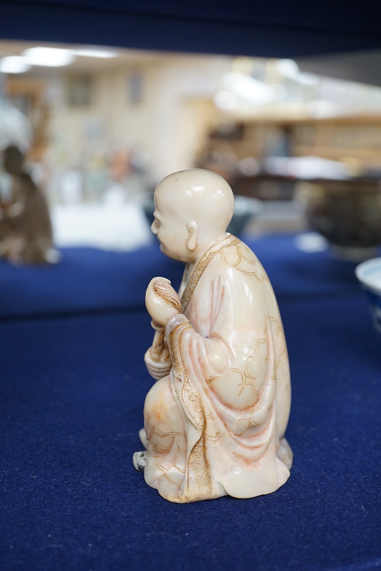 An 18th century carved soapstone figure of a seated luohan, 12cm high. Condition - good